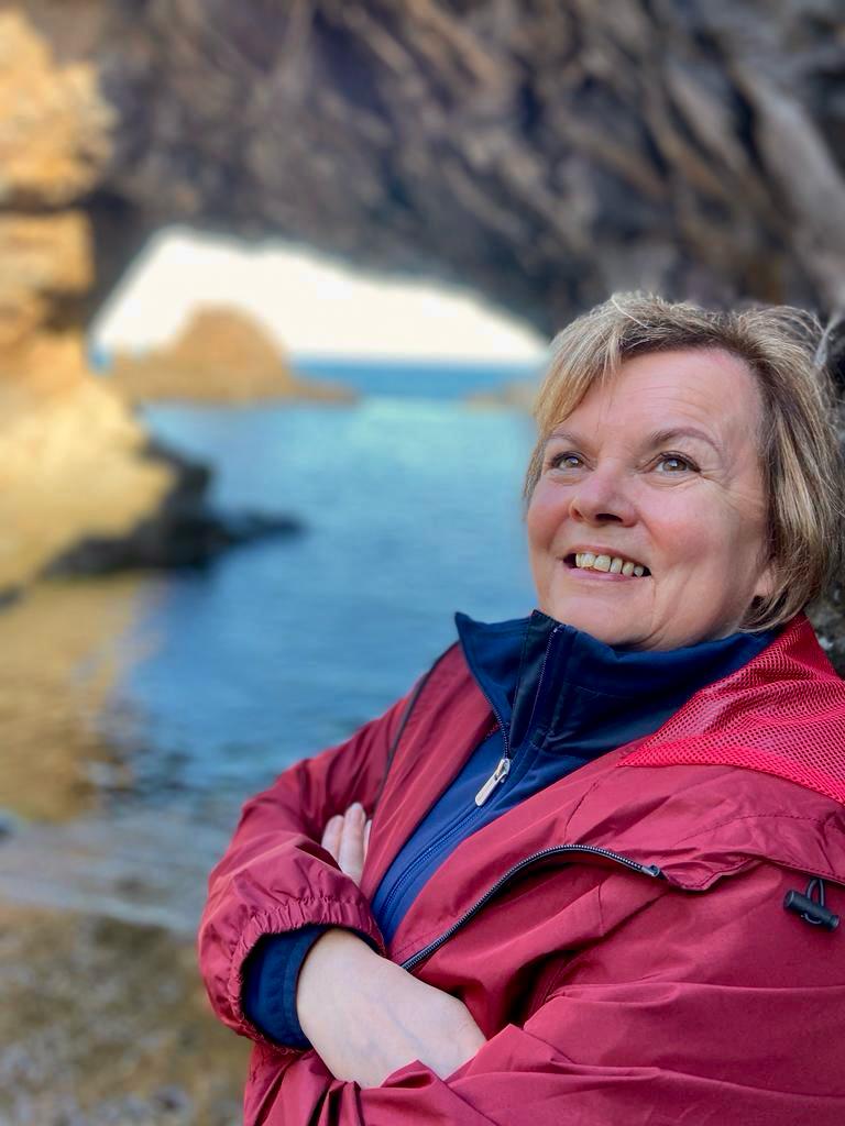 Ita Hicks, co-founder of Midlife Blush, enjoying the outdoors on a coastal walk in Portugal
